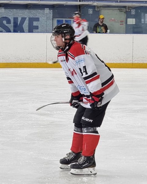 Martin in full gear playing ice hockey